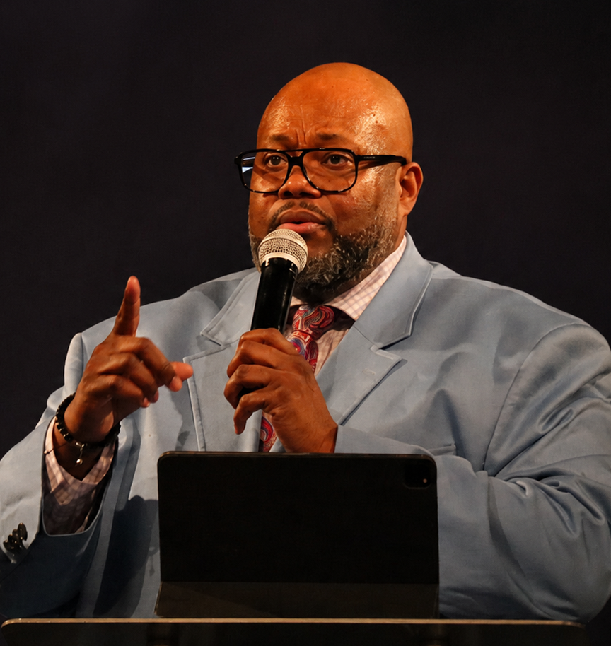 Aubrey Lee White speaking at a podium